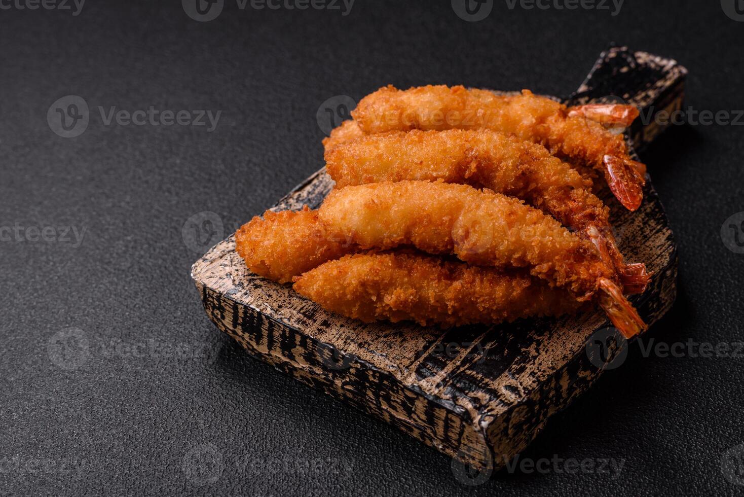 Hot crispy shrimp breaded with salt and spices with white sauce photo