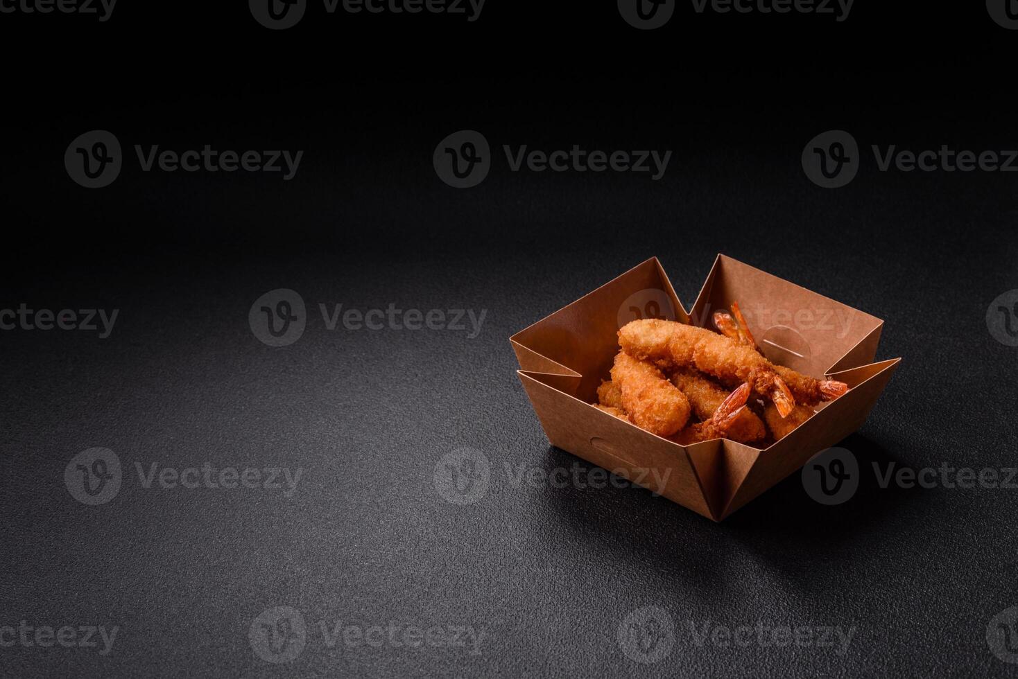 Hot crispy shrimp breaded with salt and spices with white sauce photo