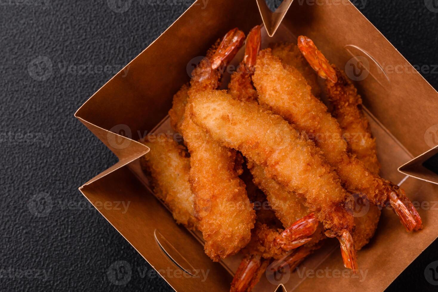 Hot crispy shrimp breaded with salt and spices with white sauce photo