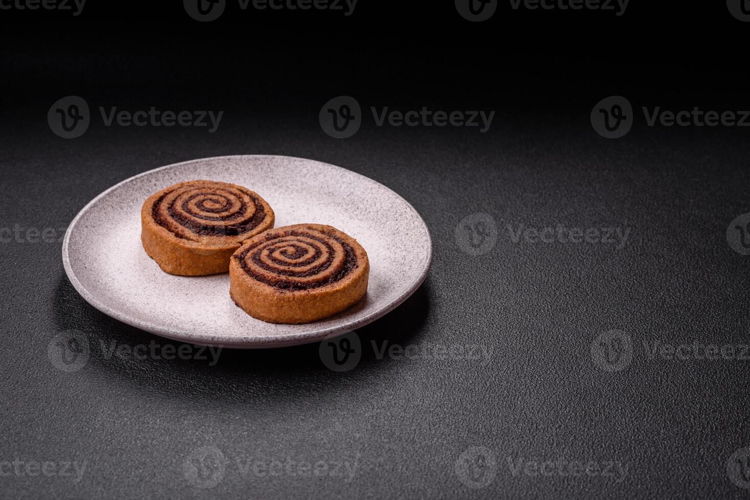 Freshly baked cinnamon roll with spices and cocoa filling photo