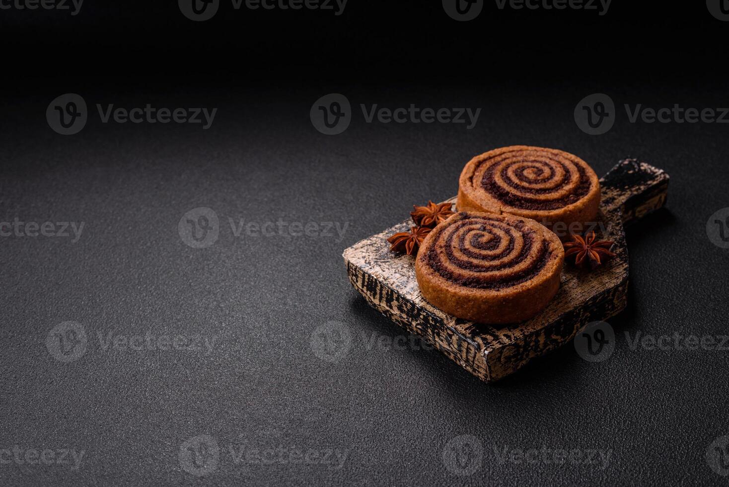 Freshly baked cinnamon roll with spices and cocoa filling photo