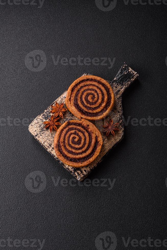 Freshly baked cinnamon roll with spices and cocoa filling photo