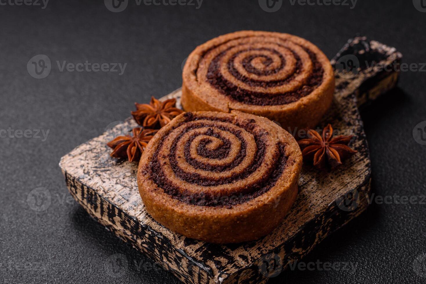 Freshly baked cinnamon roll with spices and cocoa filling photo