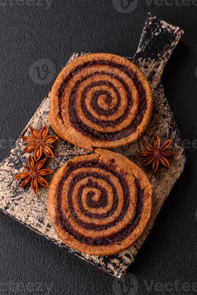 Freshly baked cinnamon roll with spices and cocoa filling photo