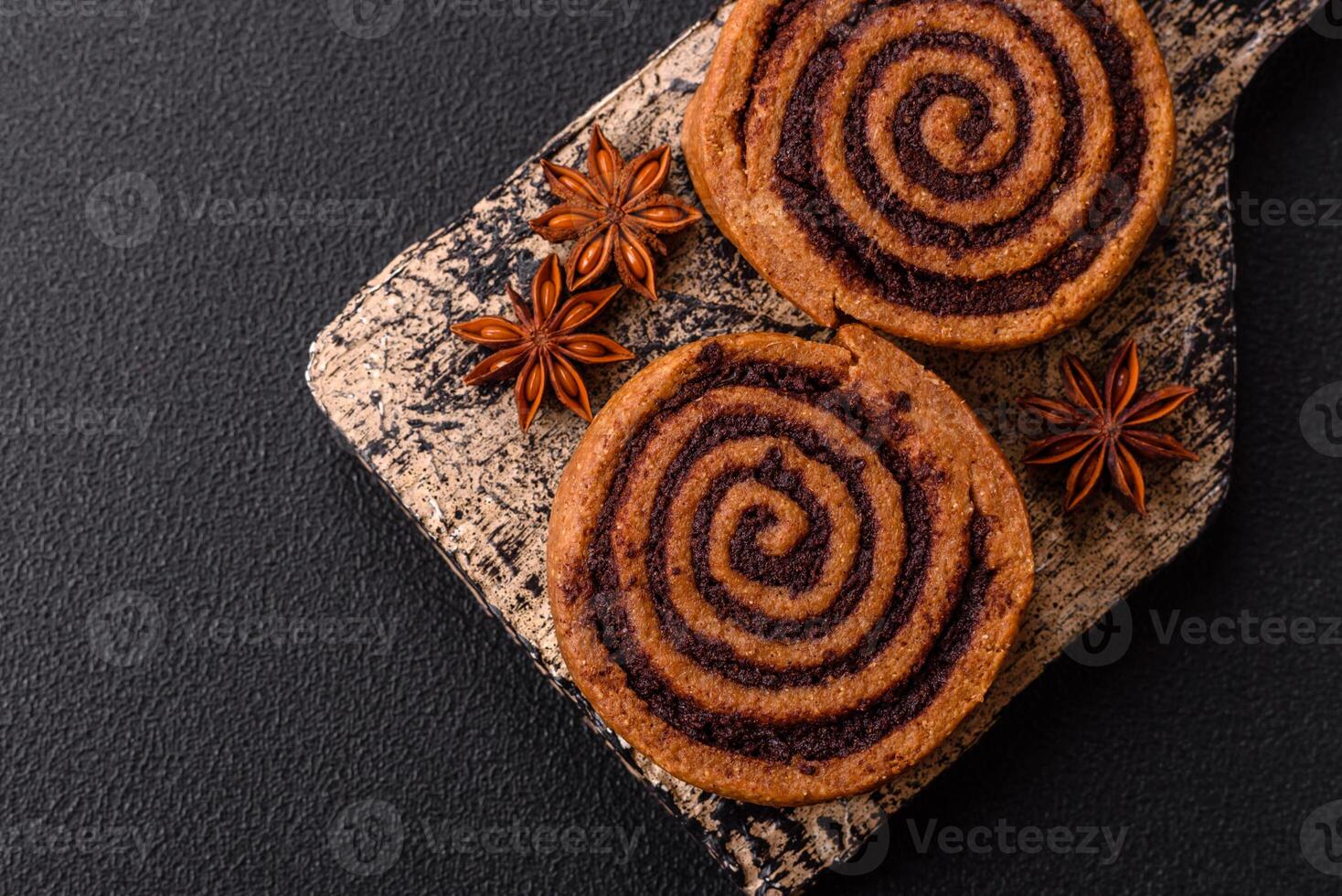 Freshly baked cinnamon roll with spices and cocoa filling photo