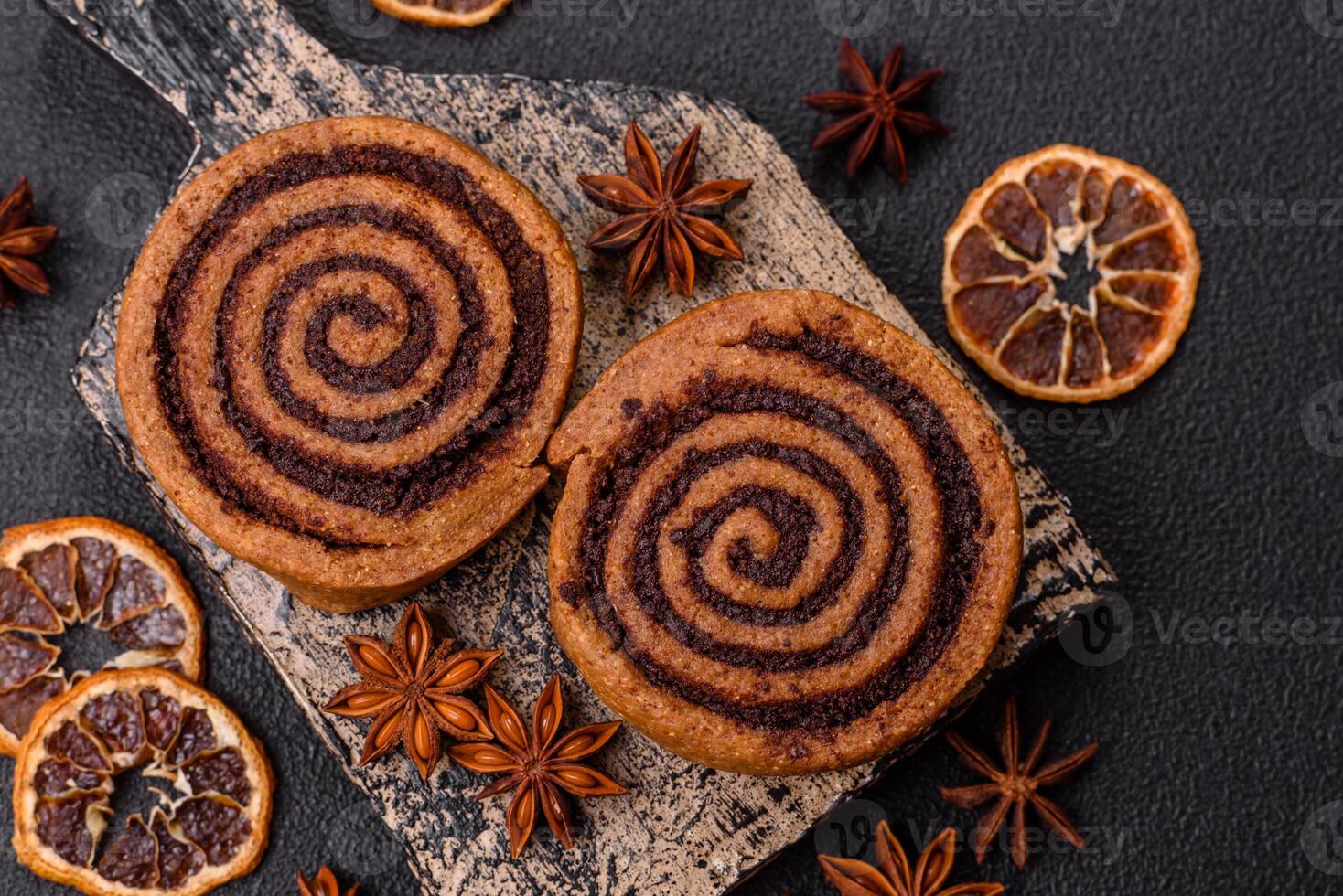 Freshly baked cinnamon roll with spices and cocoa filling photo