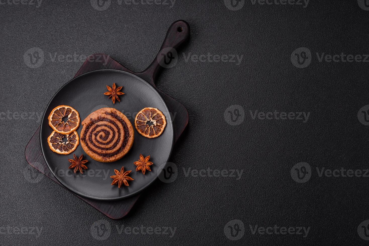 Freshly baked cinnamon roll with spices and cocoa filling photo
