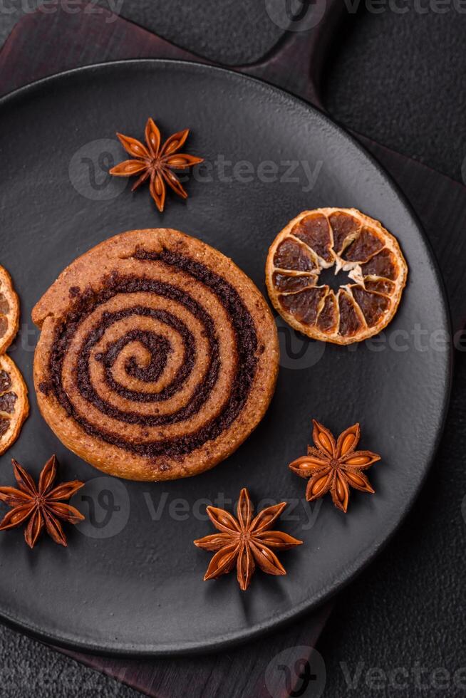 Freshly baked cinnamon roll with spices and cocoa filling photo