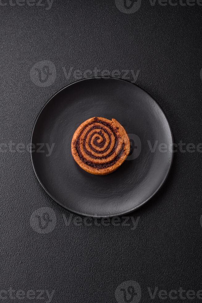 Freshly baked cinnamon roll with spices and cocoa filling photo