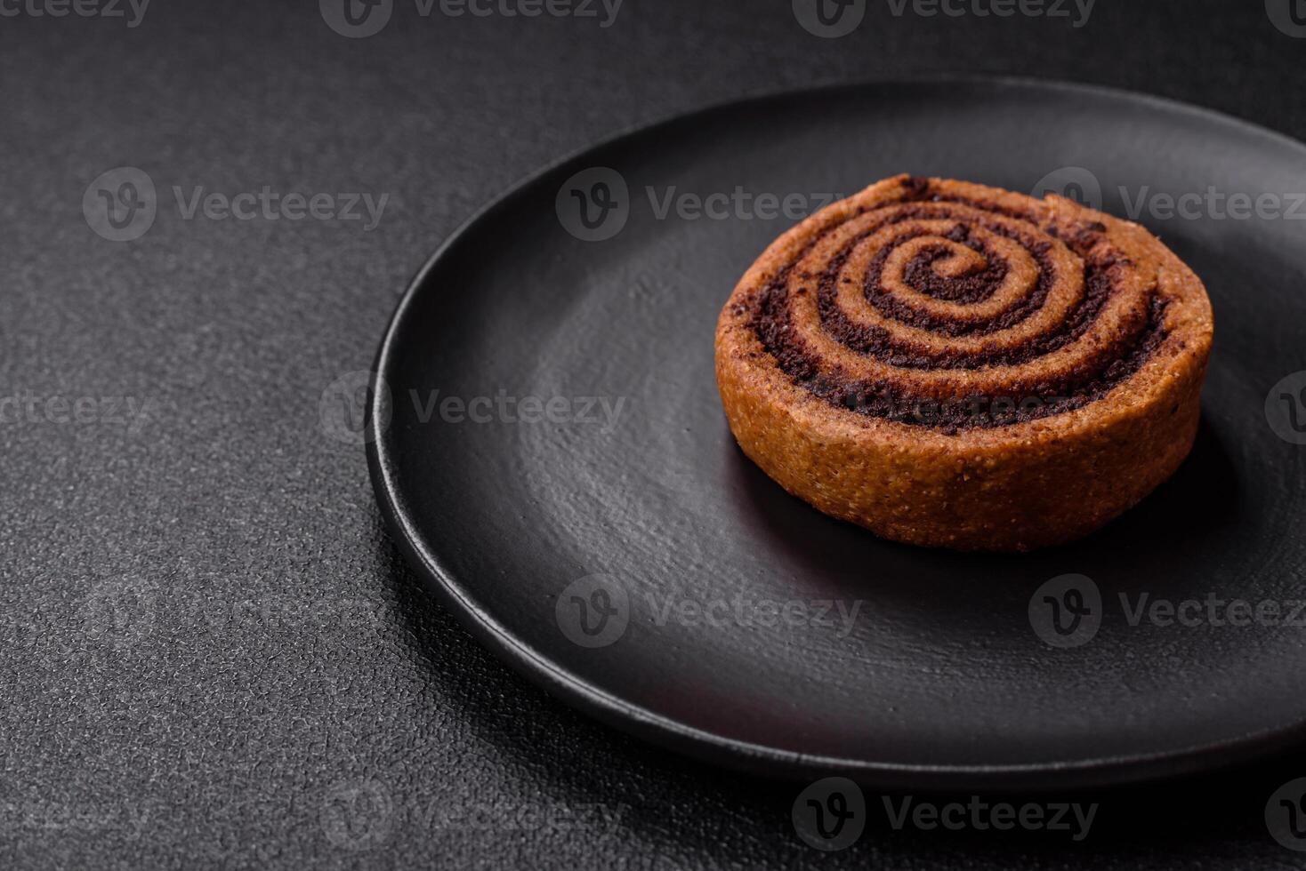Freshly baked cinnamon roll with spices and cocoa filling photo