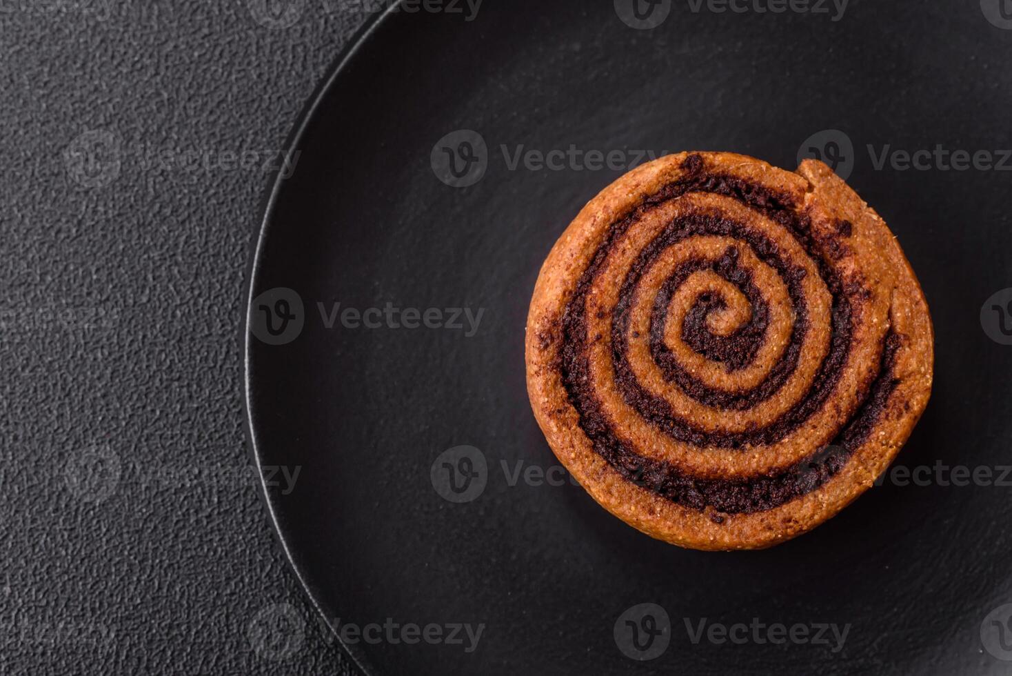Freshly baked cinnamon roll with spices and cocoa filling photo
