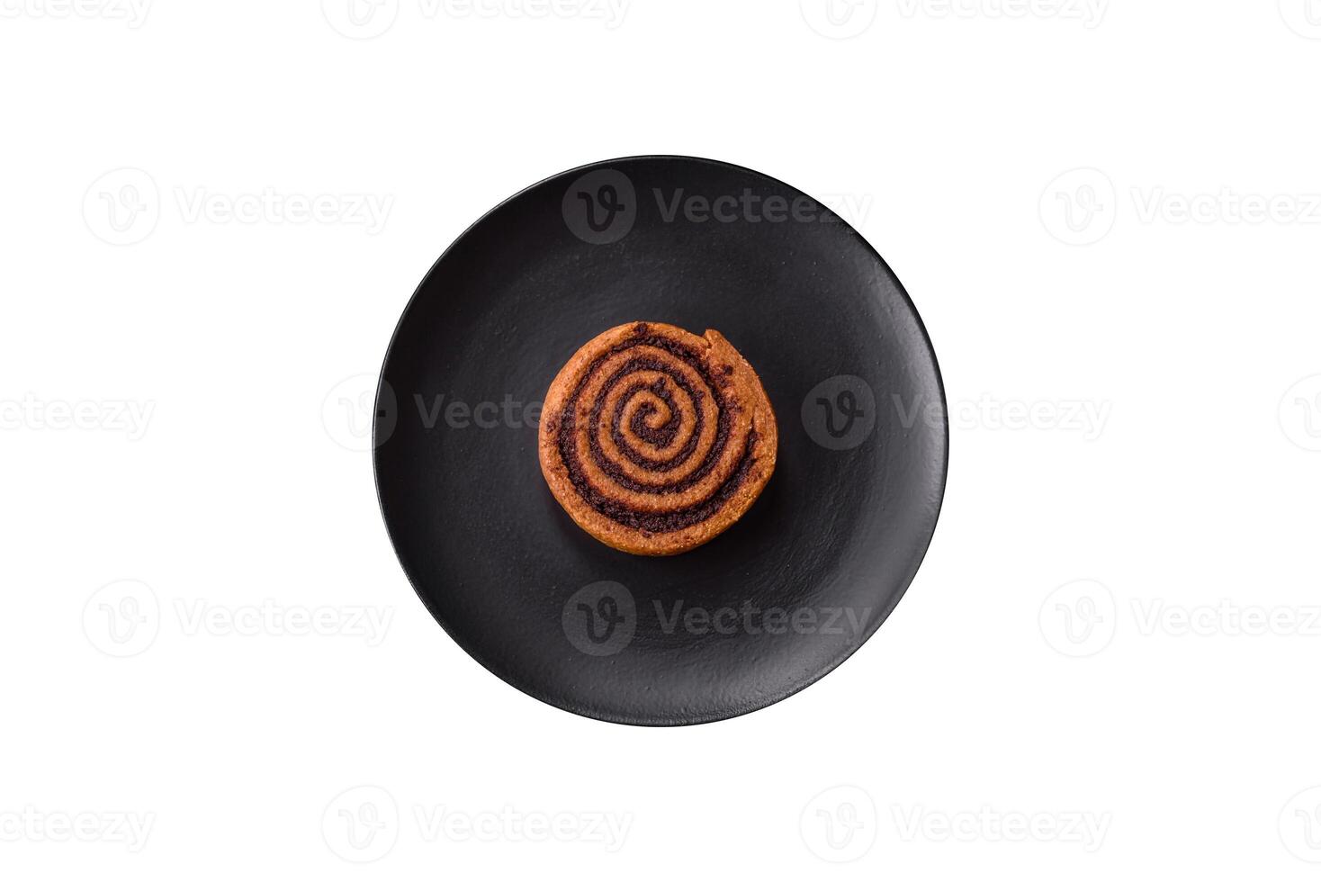 Freshly baked cinnamon roll with spices and cocoa filling photo