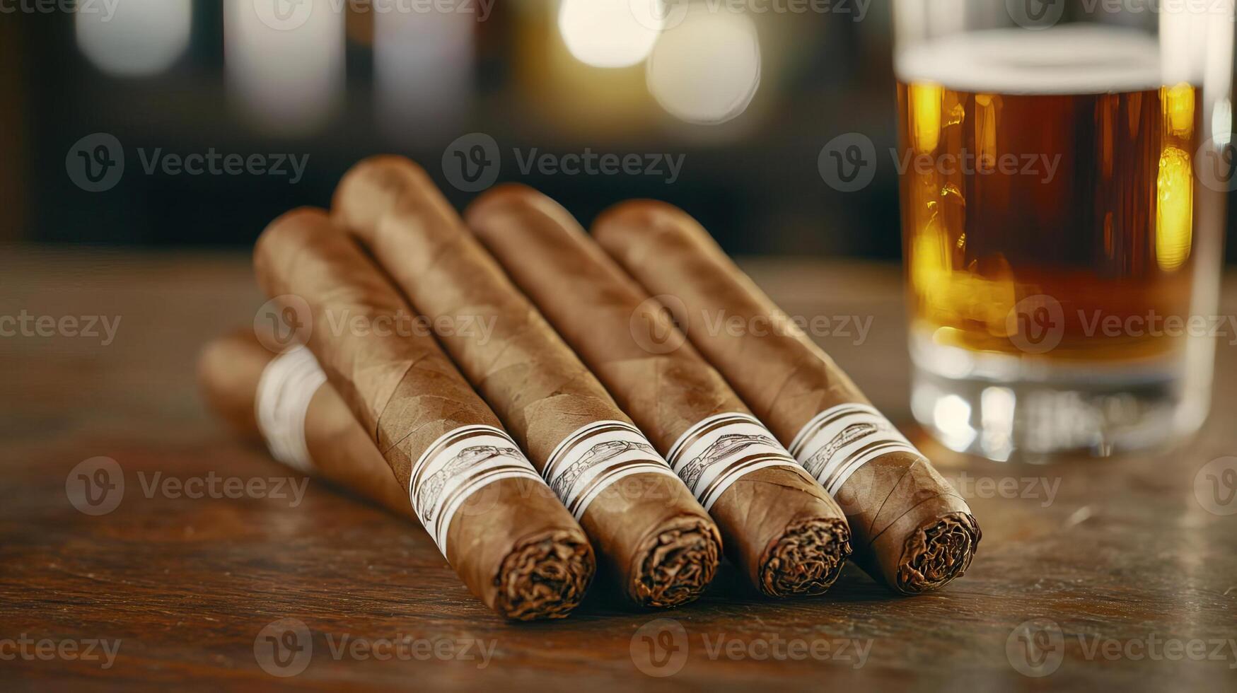 Close-up of Cuban cigars on a wooden desk, with a blurred glass of brandy for a luxurious atmosphere. photo