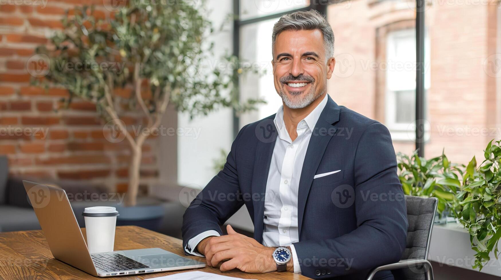 Formal Man Sitting at Desk with Laptop and Coffee photo