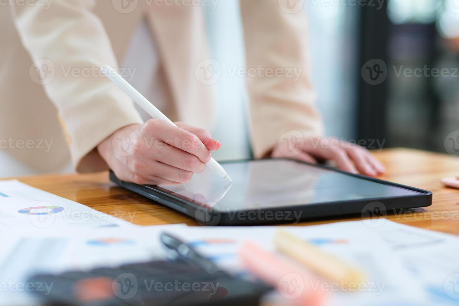 Close-up of hand signing electronic documents on a tablet with a digital pen for online workflows photo