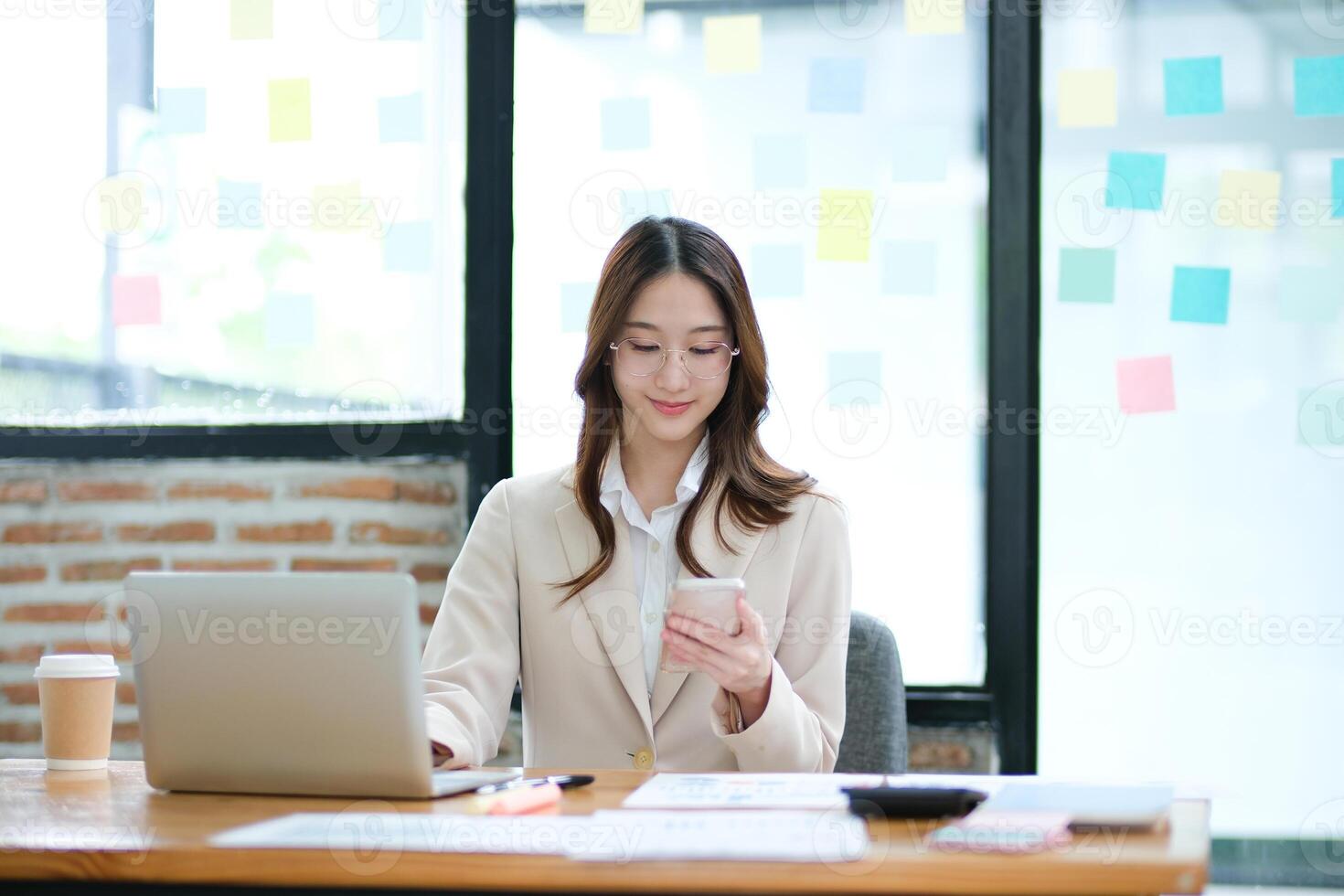 Businesswoman using a smartphone for communication, scheduling, and online business tasks. photo