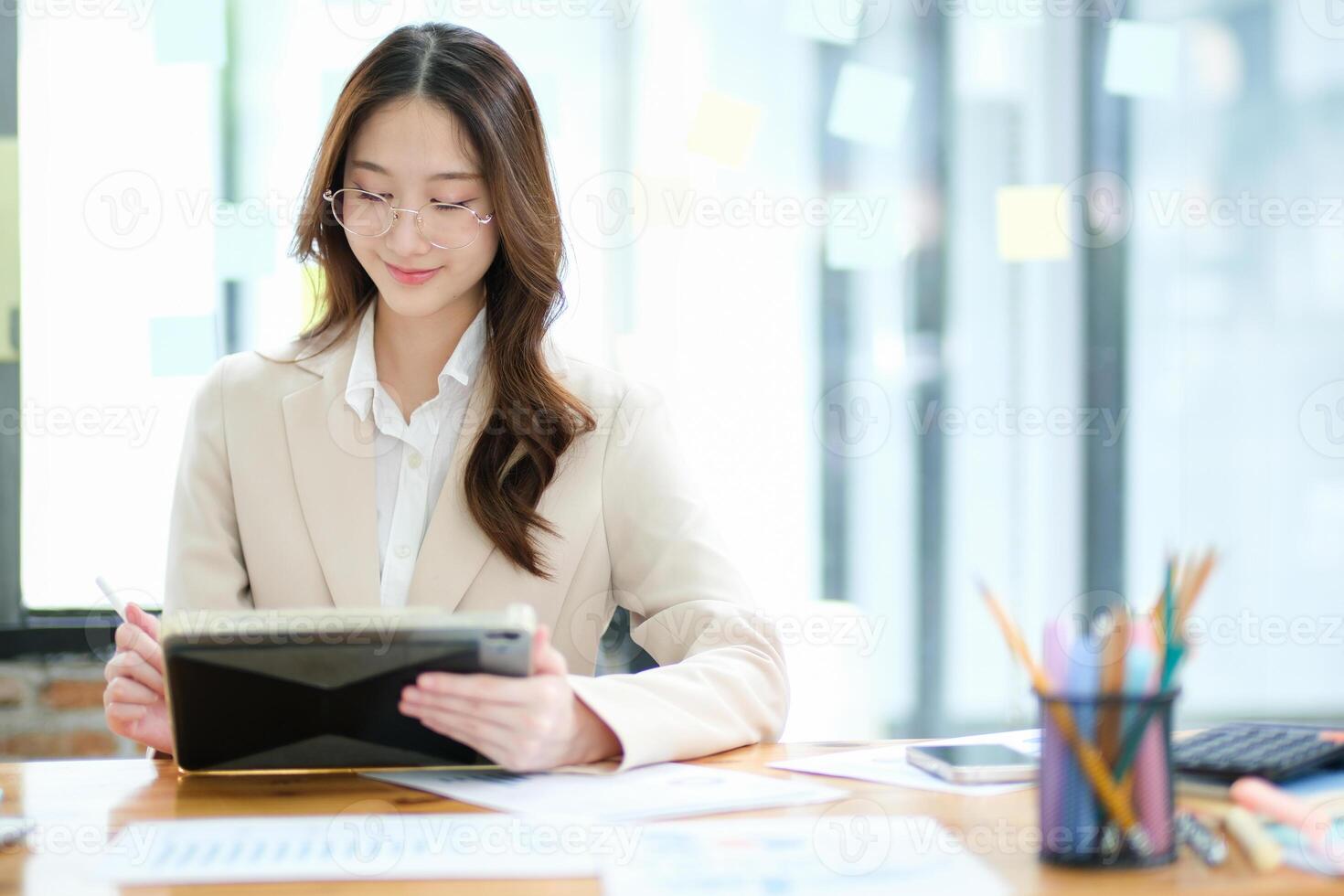 Businesswoman and entrepreneur using a tablet for data analysis and investment planning photo