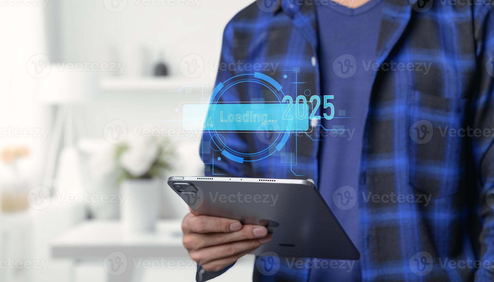 A man holding a tablet with a digital interface photo