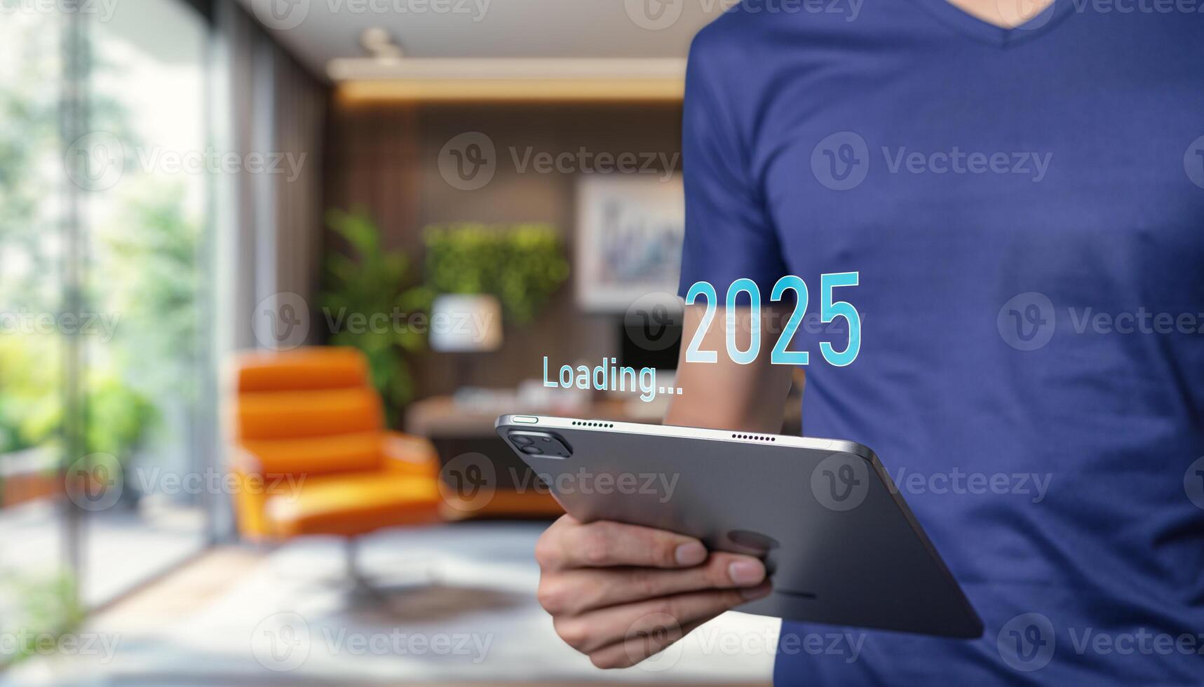 Man holding tablet with 2025 on screen photo
