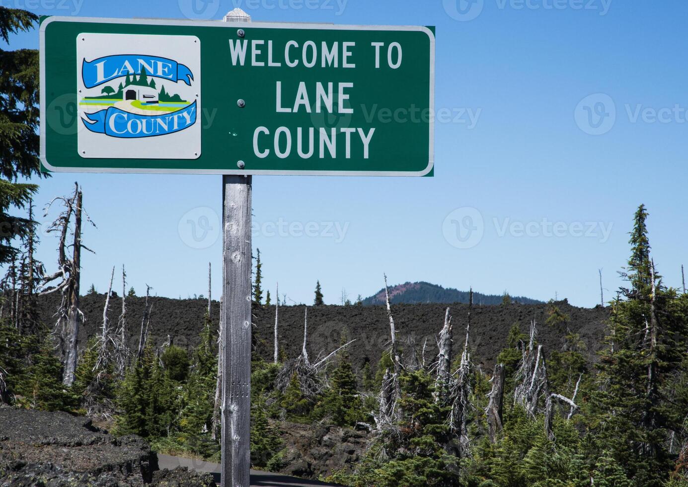 Sign in lava fields marking the boundary of Lane Count Oregon photo