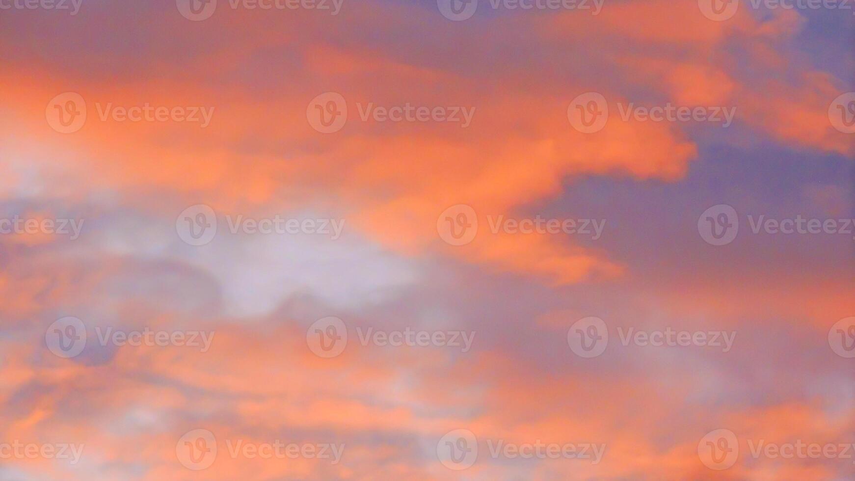 A plane flying in the sky with a red and orange sky photo