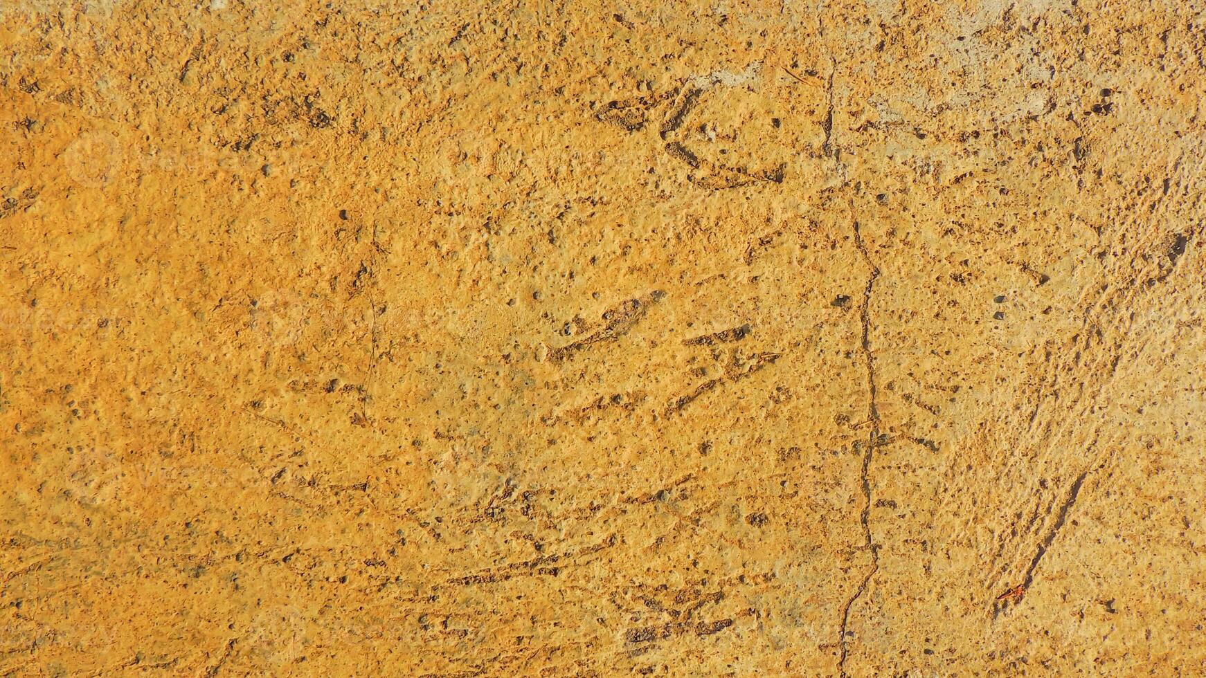 A close up of a wall with a yellow paint photo