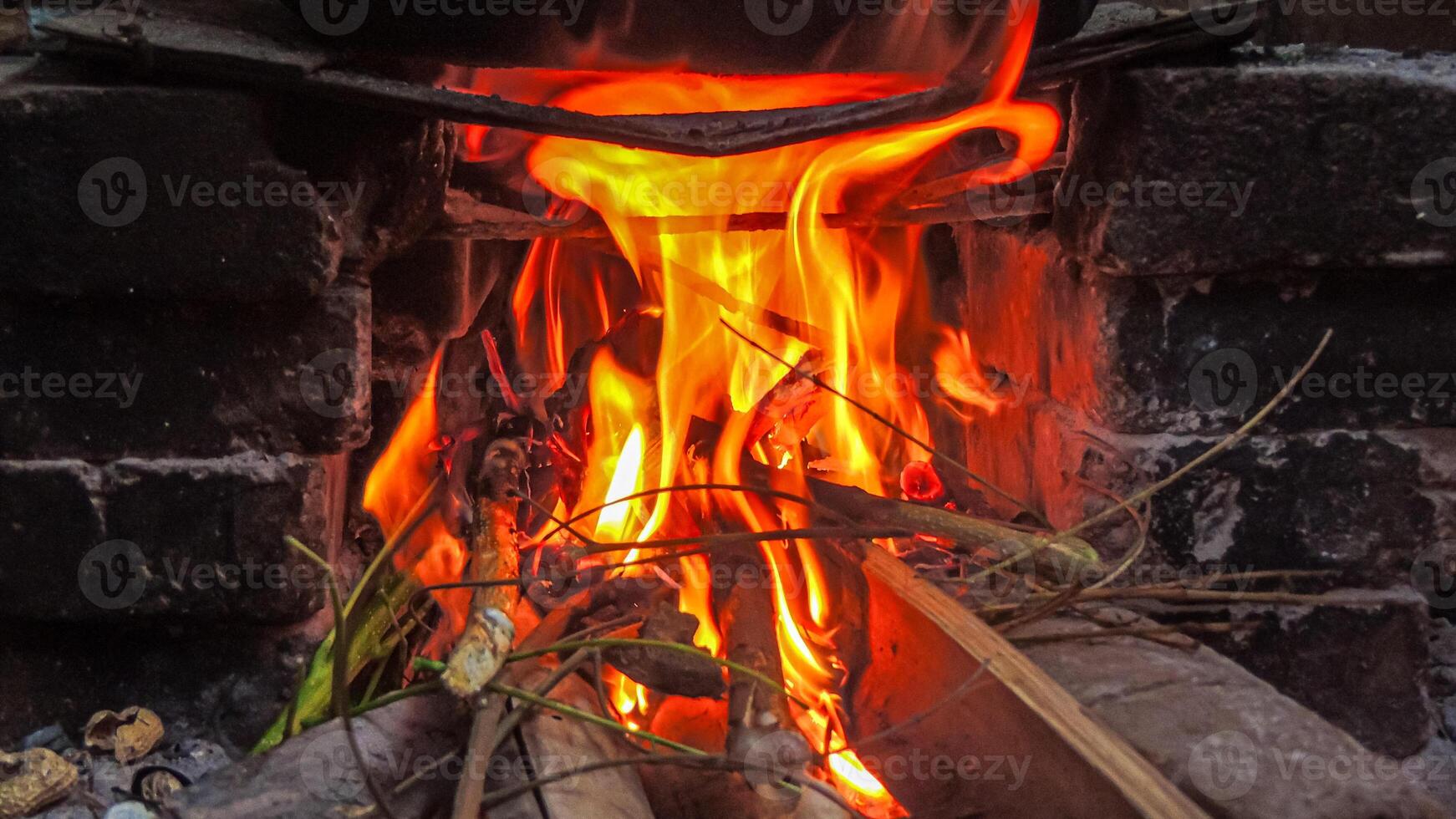 A fire is burning in a wood stove photo