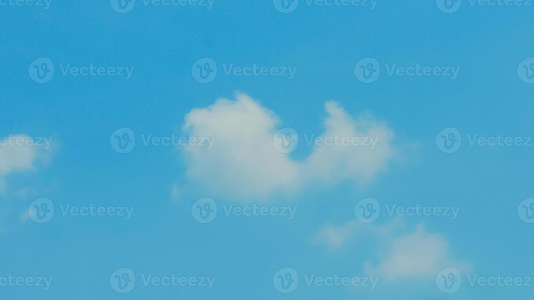 A plane flying in the blue sky with some clouds photo