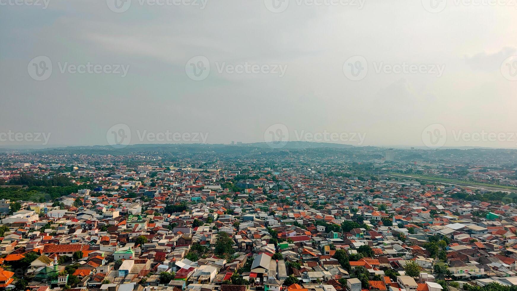 Aerial view of a city with orange roofs photo