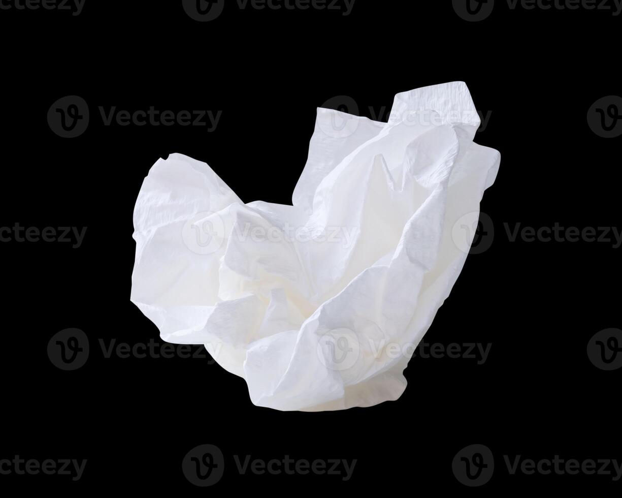 Side view of screwed or crumpled white tissue paper ball isolated on black background with clipping path photo