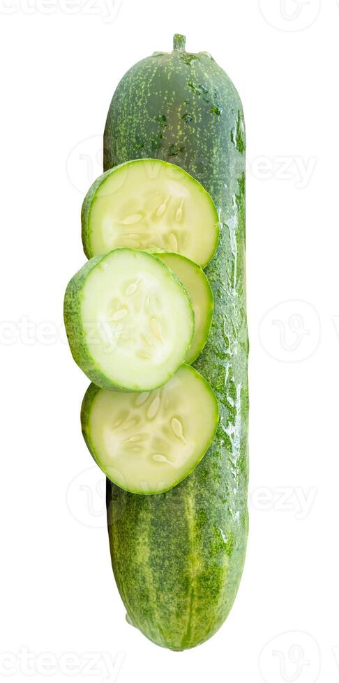 Top view of fresh green cucumber with slices in circle shape in stack isolated on white background with clipping path photo
