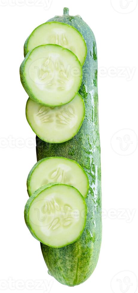 Top view of fresh green cucumber with slices in circle shape in stack isolated on white background with clipping path photo