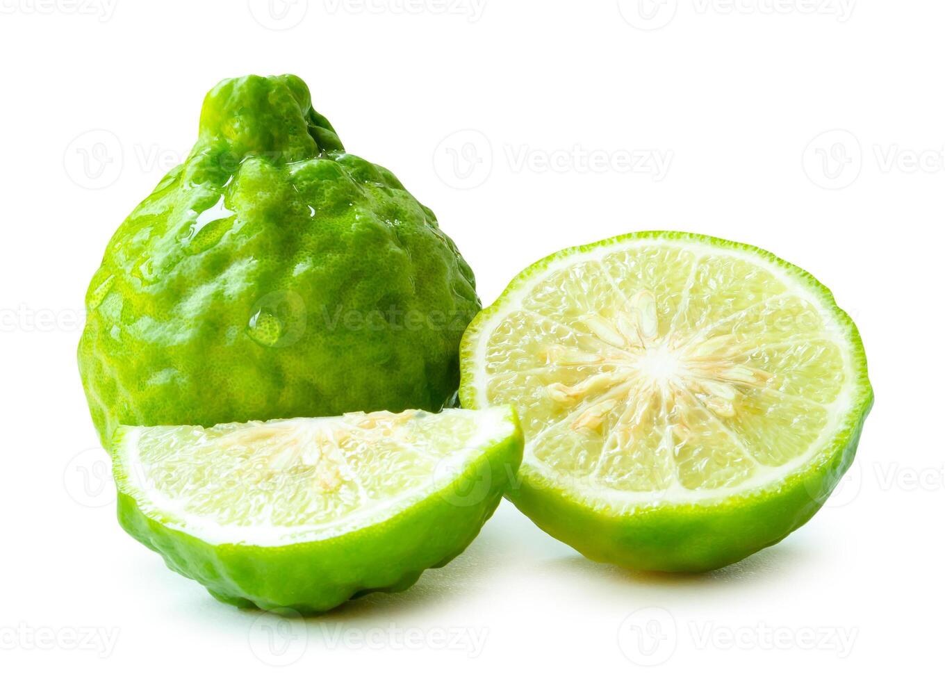 Front view of fresh green bergamot fruits or kaffir lime with half and quarter or slices but no green leaf in stack isolated on white background with clipping path photo