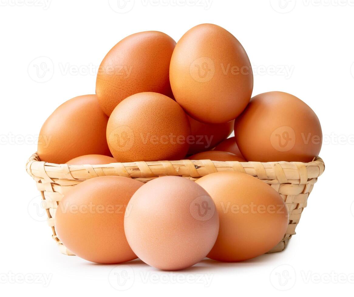 Group of fresh brown chicken eggs in stack in wicker basket isolated on white background with clipping path photo