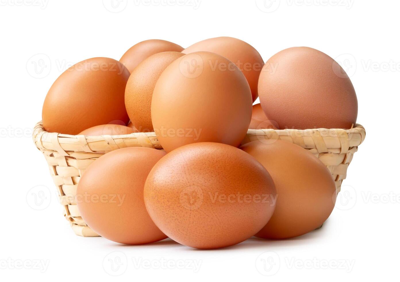 Group of fresh brown chicken eggs in stack in wicker basket isolated on white background with clipping path photo