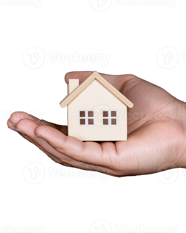 Wooden house model held in hand on transparent background png