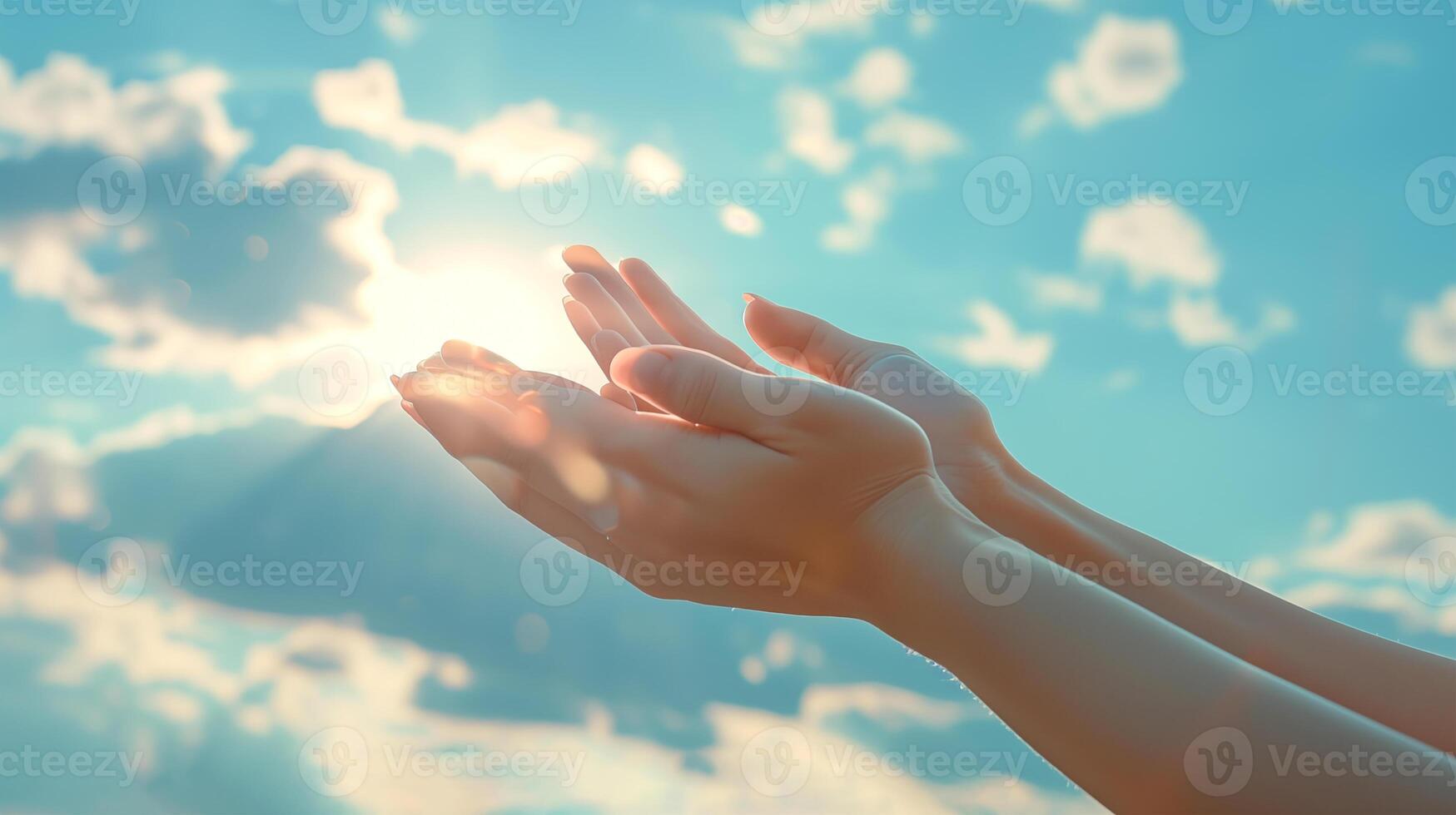 female hands with long nails with minimalist manicure are stretched out against the background of the blue sky in a prayerful or pleading gesture photo