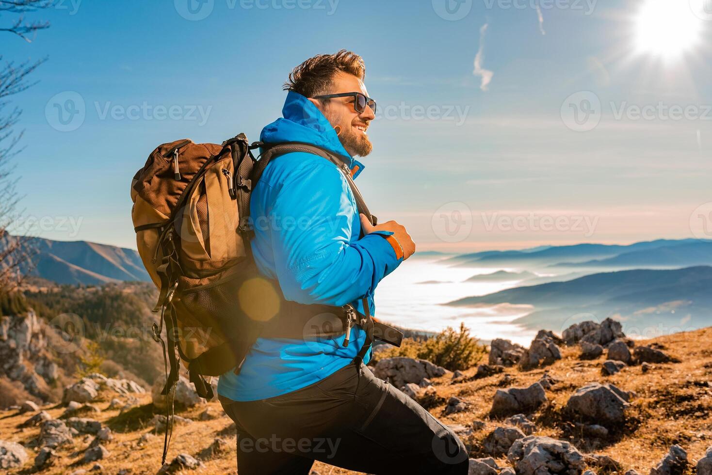 A male hiker backpacker trail hiking in the mountains adventure travel. photo