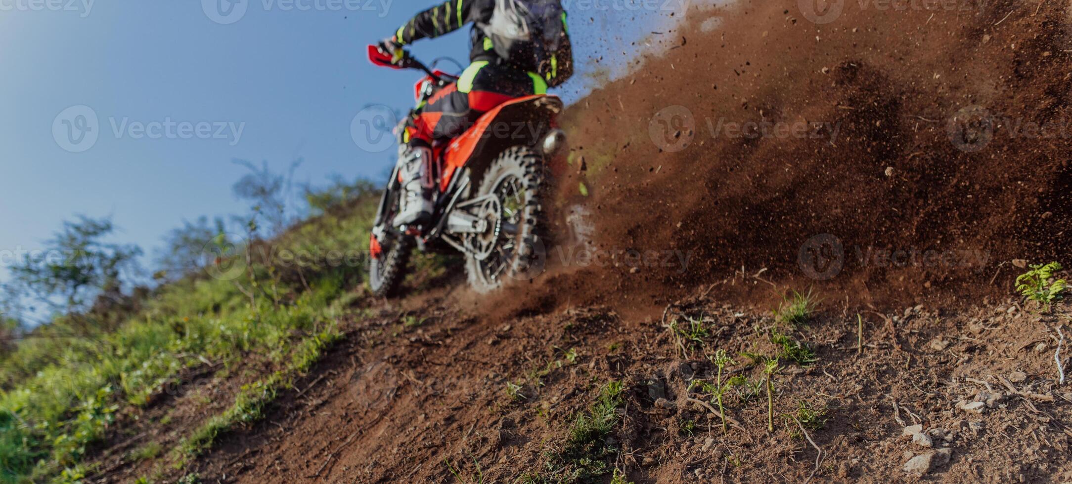 Professional enduro bike rider on action, dirt ride on the muddy road. Motocross sport. photo
