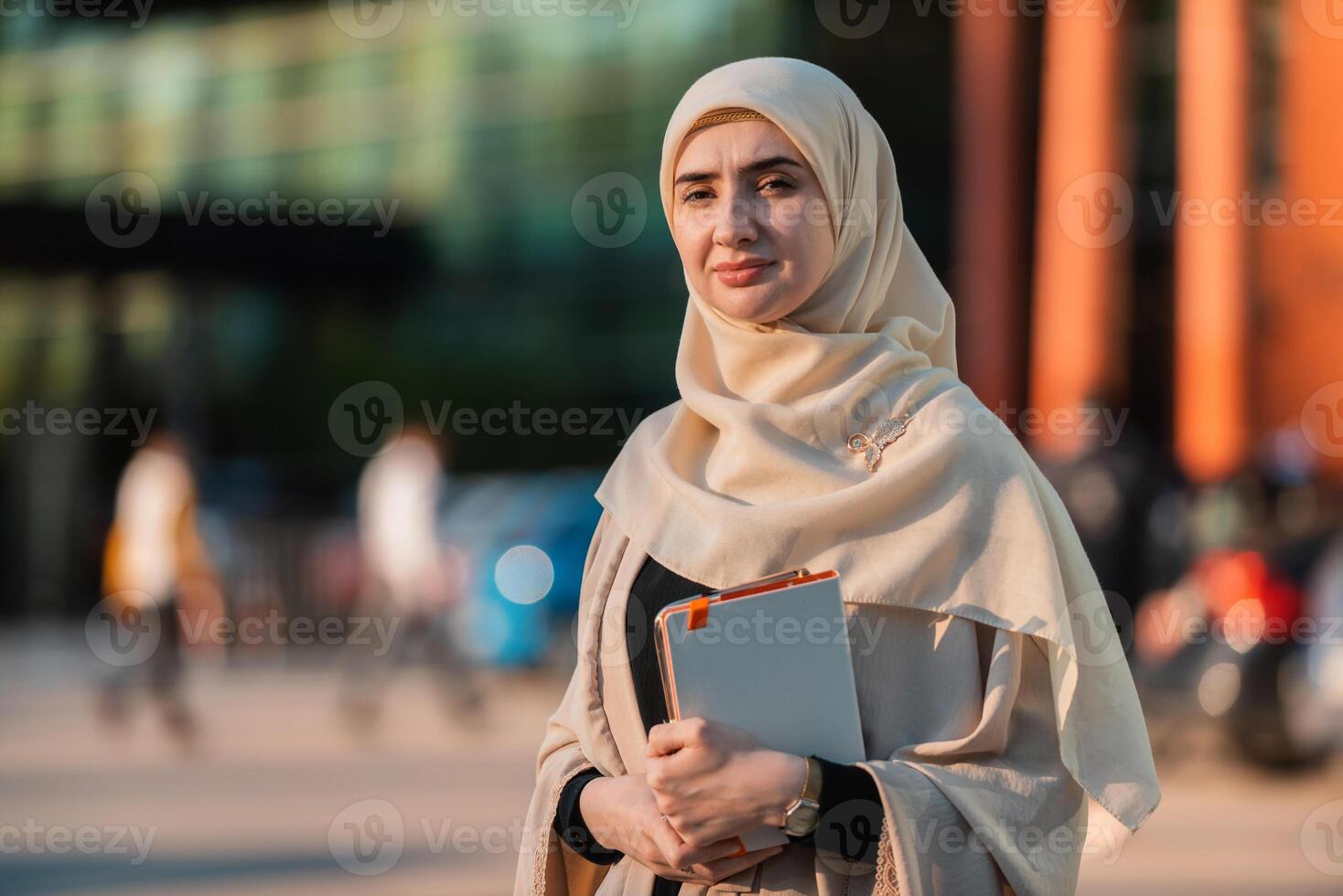 Portrait of a Muslim business woman in the city street near the office building. photo