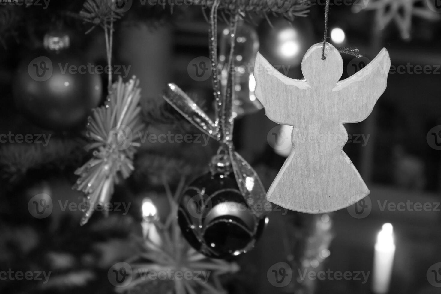Christmas Ornament on a Christmas Tree Branch with Candle Light photo