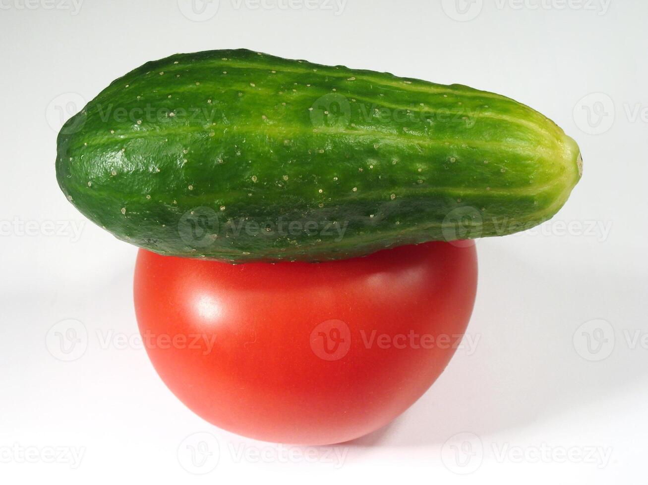 Fresh Cucumber and Tomato Stacked on White Background photo