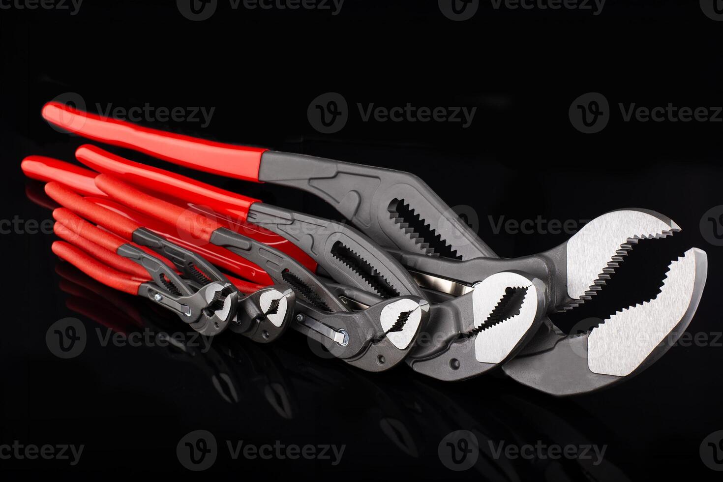 Set of Adjustable Wrenches with Red Handles photo