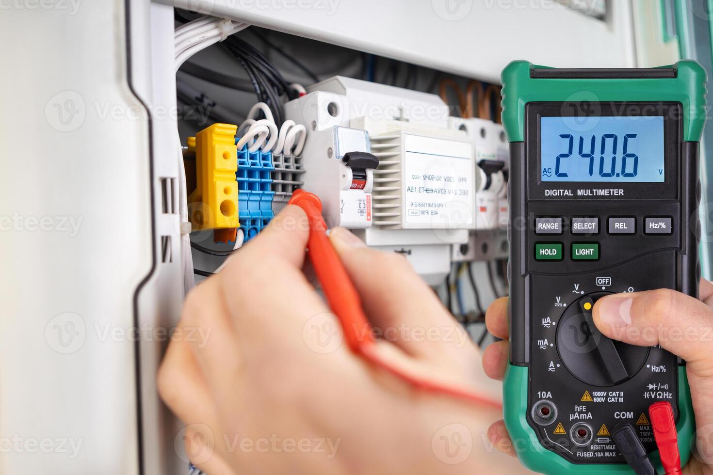 Technician Testing Voltage with Digital Multimeter photo