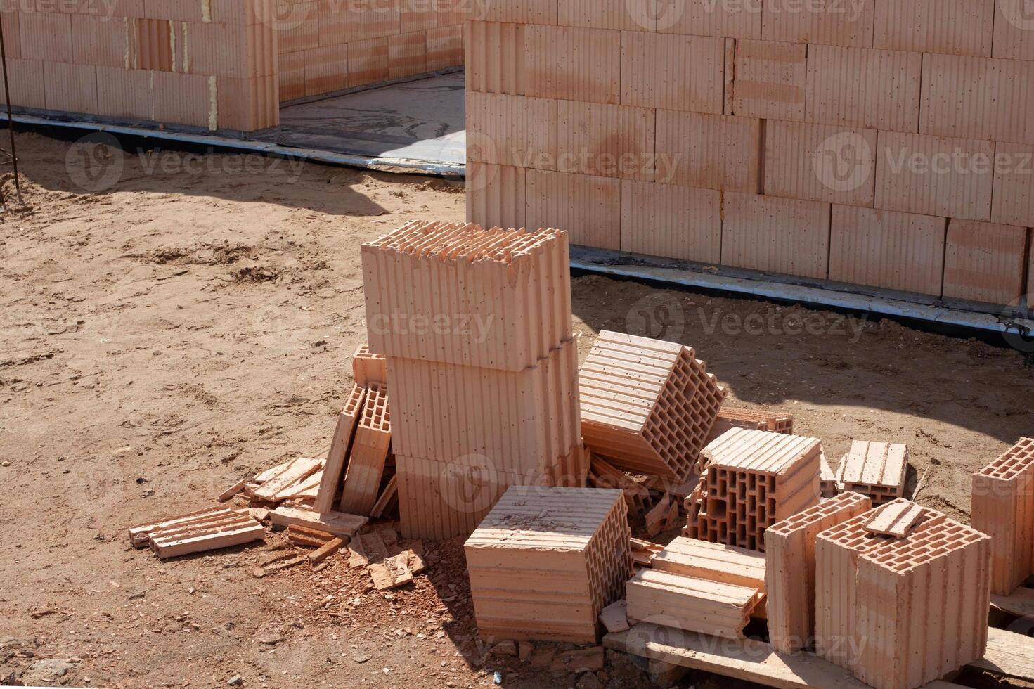 Construction site with stacked clay bricks photo
