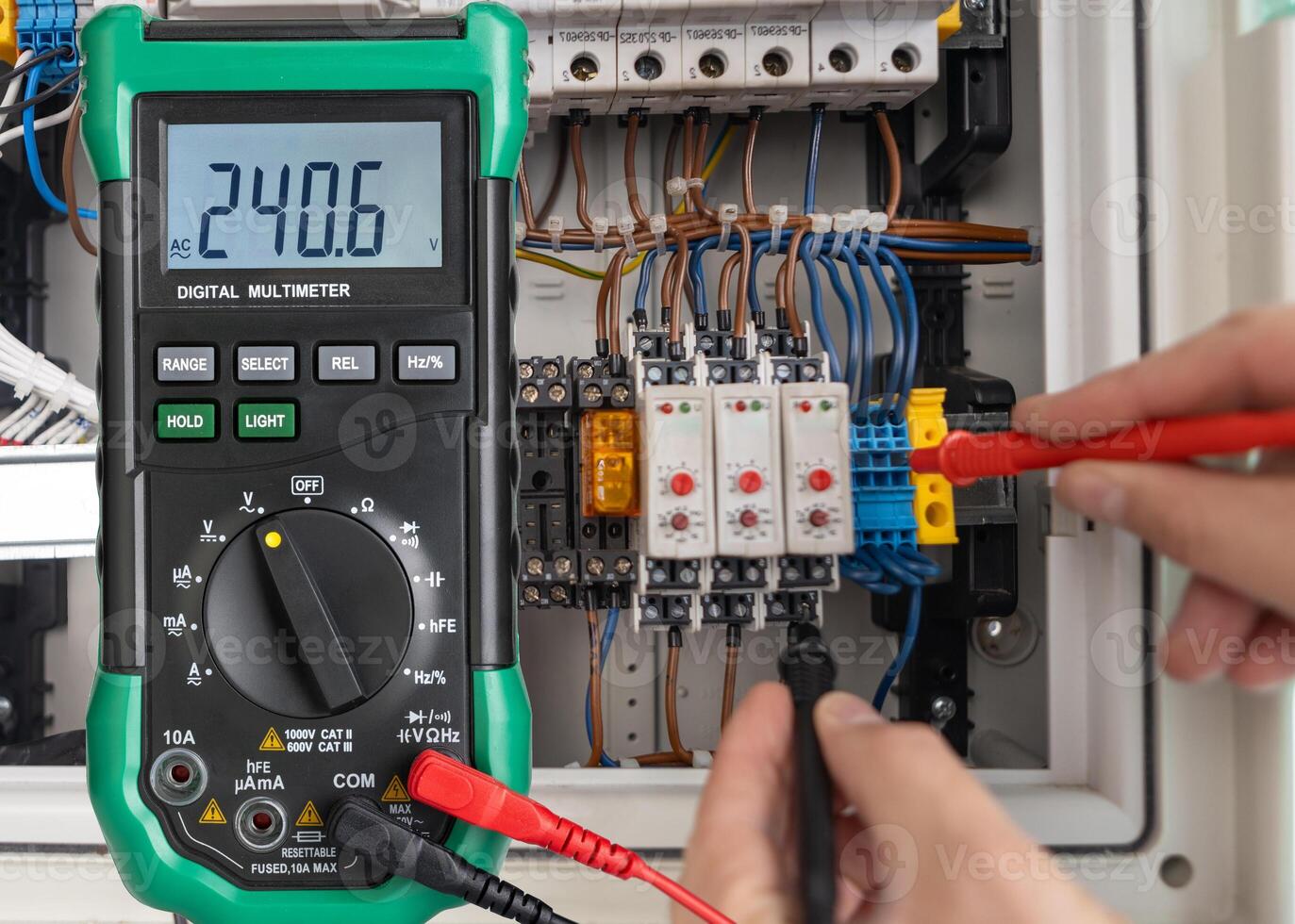 Digital Multimeter Measuring Voltage in Electrical Circuit photo
