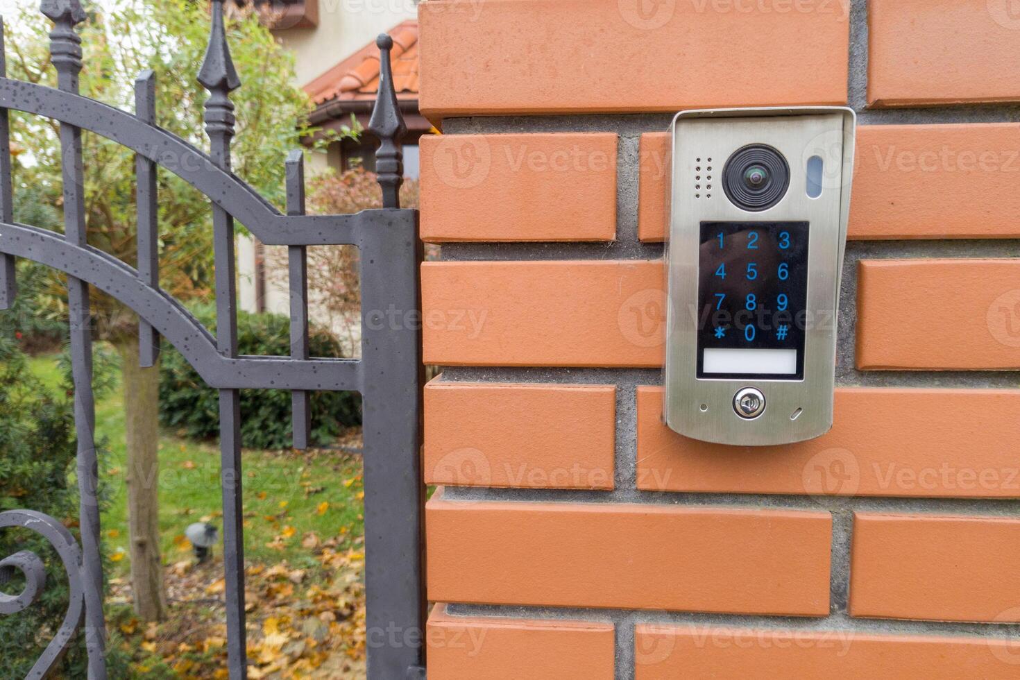Gate intercom keypad on brick pillar photo