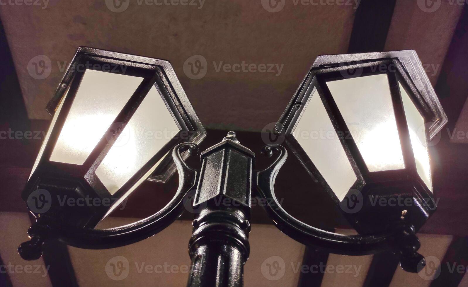 Old street lights in the dark background, vintage lamps photo
