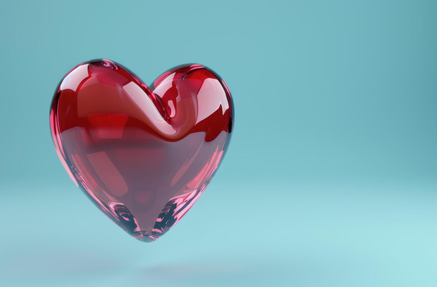 red glass heart on turquoise background photo