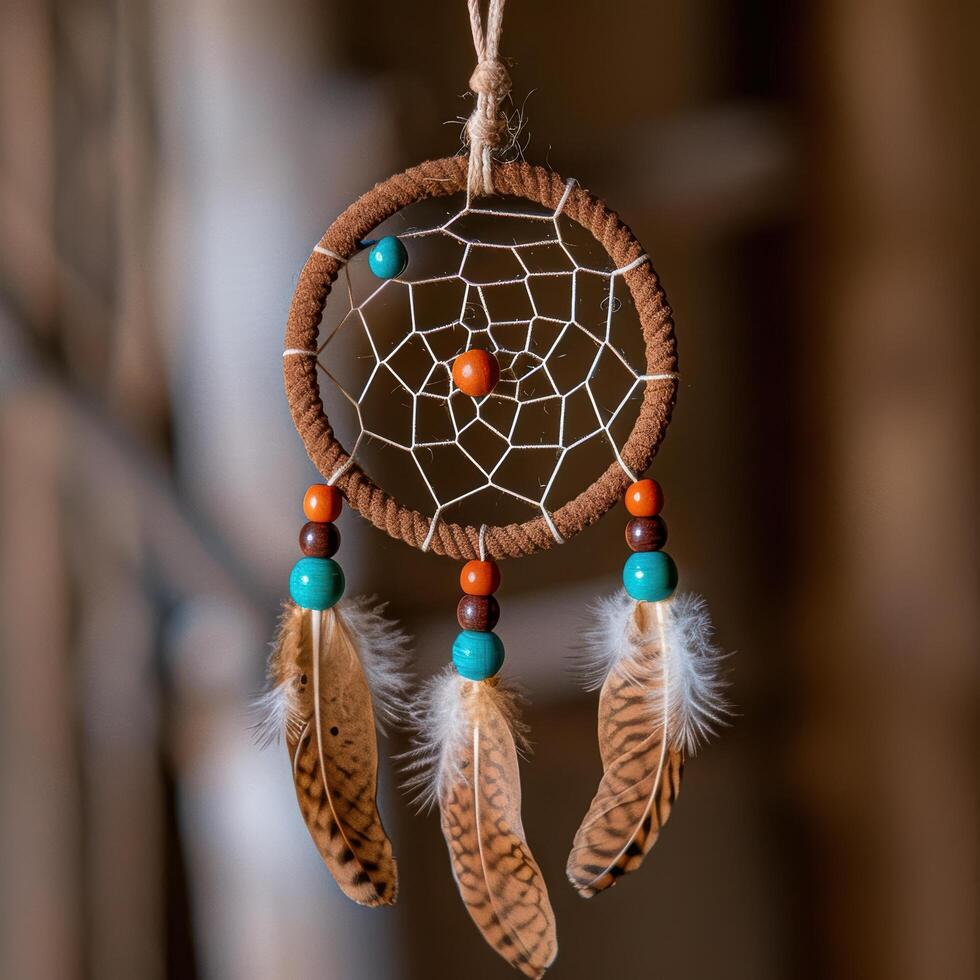 Handmade dreamcatcher with feathers and beads photo